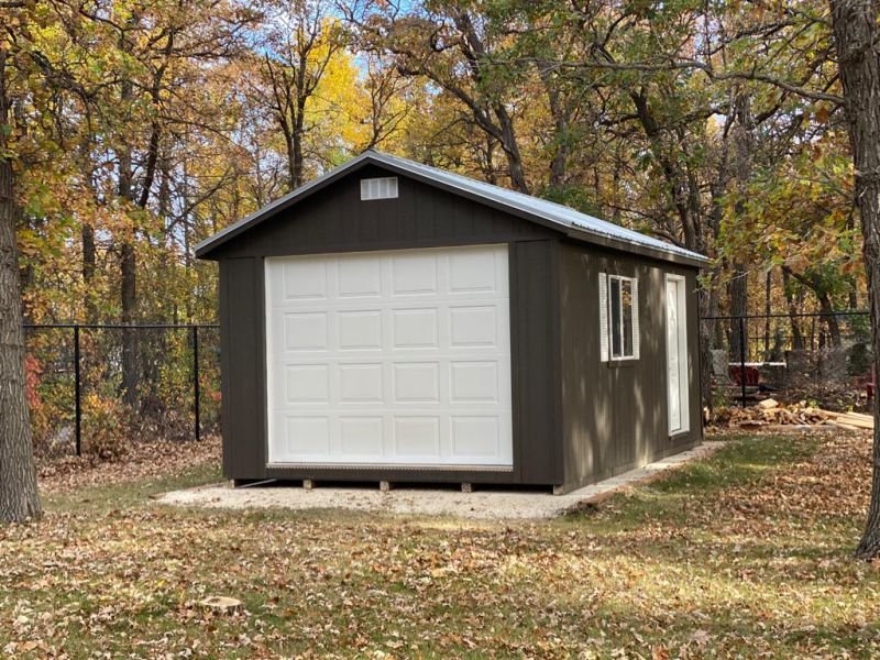 Brown ranch-style shed with garage door, featured in shed prices guide