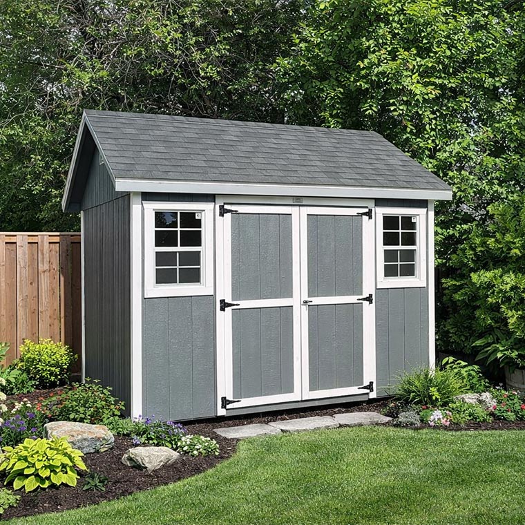 Gray shed with white trim after a shed inspection