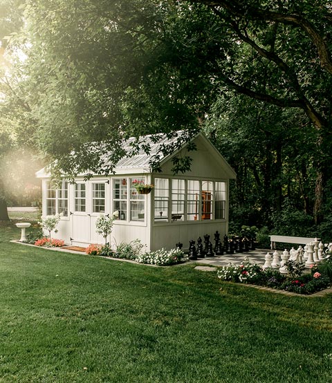 Horizon Storage Sheds, beautiful landscaping with greenhouse.